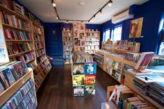 a room filled with lots of books and dvds on shelves next to eachother