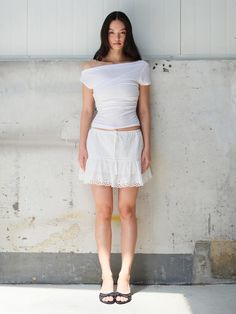 The Garden Mini Skirt is a charming and delicate piece designed to elevate any summer wardrobe. It features intricate lace detailing at the hem, giving it a romantic and feminine appeal. The lightweight fabric ensures comfort and breathability, making it perfect for warm weather. - This Garden Mini Skirt includes intricate lace detailing along the hem for an elegant touch.- The lightweight fabric offers comfort and breathability, ideal for warm weather.- It features a flattering silhouette that enhances the wearer's figure while providing ease of movement.- A handmade Cali medal decoration has been attached to the lower right side of the front panel to add a unique point of interest. Feminine Flowy Mini Skirt With Lace Trim, Chic Lace Top Skirt For Spring, Summer Beach Mini Skirt With Lace Trim, Summer Stretch Mini Skirt With Lace Trim, Summer Skirt With Lace Trim And Stretch, Summer Mini Skirt With Lace Trim, Stretch Skirt With Lace Trim For Summer, Mini Skirt With Lace Trim For Summer, Lace Trim Mini Skirt For Summer