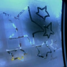 the window is frosted and has stars drawn on it