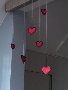 some red hearts are hanging from the ceiling