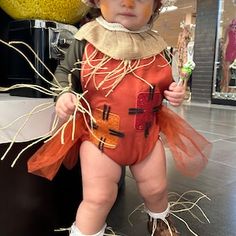 a little boy dressed up as a scarecrow