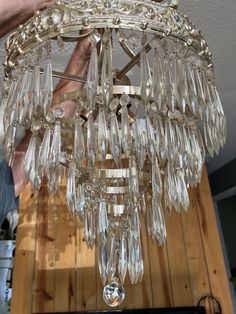 a chandelier hanging from the ceiling in a room with wood floors and walls