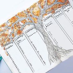 a tree is shown on top of a notebook with pencils and paper next to it