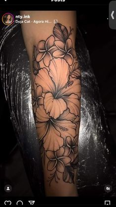 an arm with flowers on it and the words, my ink is done in black