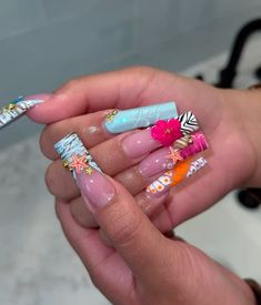 a person holding some colorful nail polish in their hand