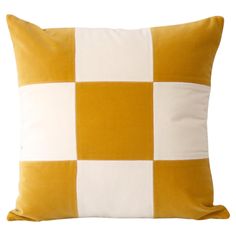 a yellow and white checkered pillow on a white background