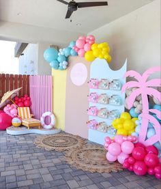 a room decorated with balloons and decorations for a baby's first birthday or party