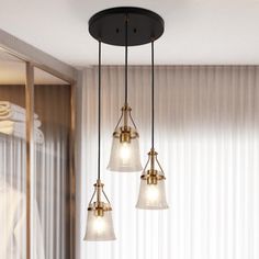 three lights hanging from a ceiling in a room