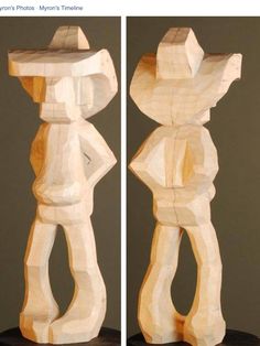 two wooden sculptures sitting on top of a black table next to each other in front of a facebook page