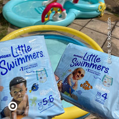 two baby diapers sitting next to each other on top of an inflatable pool