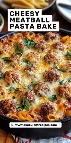 cheesy meatball pasta bake in a black pan with cheese and basil