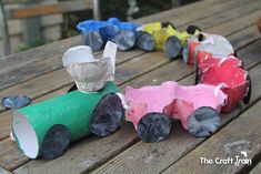 the paper cars are all lined up on the picnic table and ready to be painted