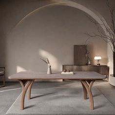 a table with two vases on it in front of a wall and a fireplace