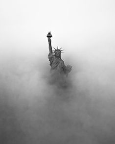 the statue of liberty is surrounded by fog