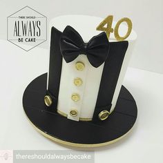 a black and white cake with a bow tie on it's top that says 40 always be cake