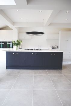 a large kitchen with an island in the middle