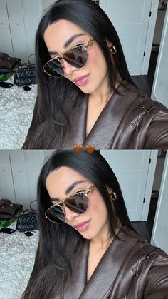 a woman with heart shaped sunglasses on her face and in front of the camera, she is wearing a brown leather jacket