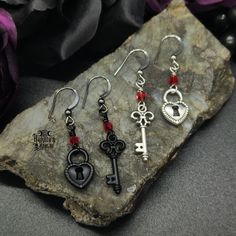 Embrace this Valloween with these enticing Locked Up Heart Earrings. These asymmetrical beauties are sure to enhance those victorian, vampy, goth vibes in your look. Enhance your gothic vampire look and pair with our matching choker/necklace. Happy Valloween!Locked Up Heart Earrings Details: Fashion Jewelry ~ Handmade Asymmetrical Ruby Crystal Accents Key Length: 53mm Heart Lock Length: 46mm Key Earrings Aesthetic, Victorian Goth Jewelry, Vampire Jewelry, Vampire Look, Goth Vibes, Key Earrings, Rose Choker, Weird Jewelry, Goth Earrings