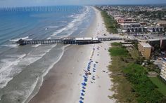 an aerial view of the beach and pier