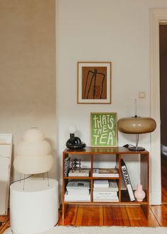 a living room filled with furniture and a lamp on top of a wooden table next to a doorway