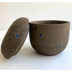 two stone bowls sitting next to each other