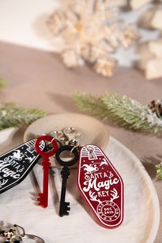 two keys are sitting on a plate next to some christmas decorations and snowflakes