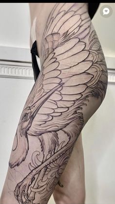 a woman's leg with an eagle tattoo on it