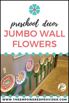 some paper plate flowers are hanging on the wall with text overlay that reads preschool decor jumbo wall flowers