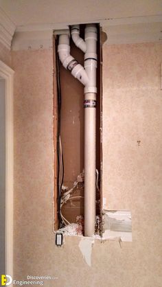 an unfinished bathroom with exposed pipes in the wall