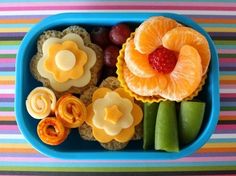 a blue plate topped with fruit and veggies