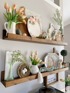 two wooden shelves filled with plates and flowers