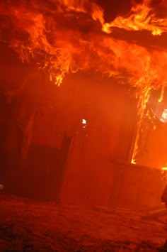 a firefighter standing in front of a burning building