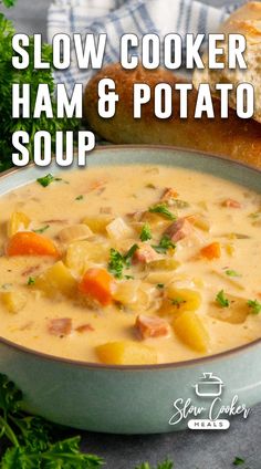 slow cooker ham and potato soup in a blue bowl with bread on the side