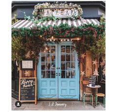 the front entrance to a restaurant with blue doors and green trimmings on it