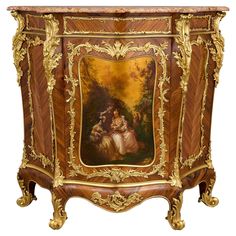 an ornate wooden cabinet with paintings on the front and side panels, painted in gold