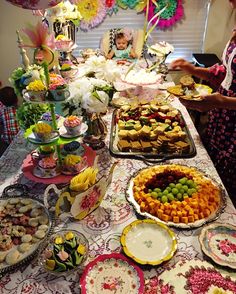 a table filled with lots of food and desserts