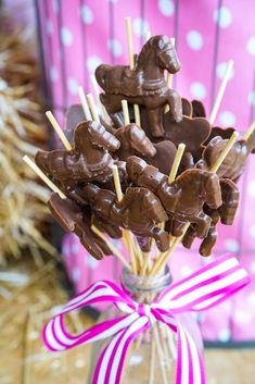 chocolate candies are arranged in a glass vase