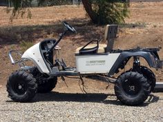 an off - road vehicle is parked on the gravel