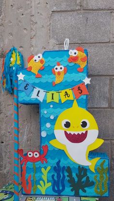 the letter f is made out of cardboard and painted like a shark, fish, and seaweed