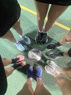 a group of people standing in a circle with their feet together