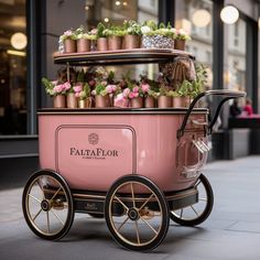 a pink cart filled with lots of potted plants