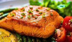 salmon, asparagus and tomatoes on a plate