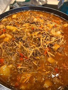 a large metal pan filled with food on top of a stove