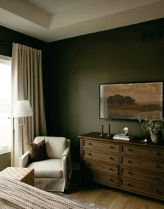 a living room with a couch, chair and dresser