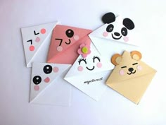 four envelopes with panda faces and numbers on them, one has a flower in the middle