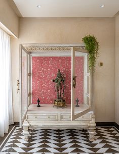 a room with pink walls and black and white checkered flooring on the floor