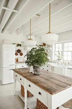 a kitchen with a wooden table and white appliances