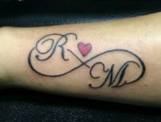 a tattoo with the initials and heart on it