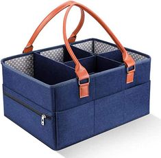 the large blue tote bag has two compartments for storage and is also available with an orange leather handle