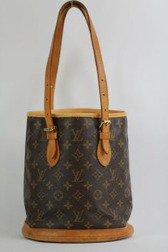 Authentic LOUIS VUITTON  M42238 Petit Bucket PM  Monogram Canvas with CERTIFICATE OF AUTHENTICATION 100% Authentic or Money Back Guaranteed if proven fake Very elegant Great as a day bag, goes with almost all outfit. Great staple to keep in your closet! Just take a look at the picture! You will receive the exact items pictured above so please look at the pictures closely so you know what you're buying  OUTSIDE: Rank BC INSIDE: Rank SA CONDITION - DESCRIPTION OF RANK: N Brand-new, unused, unworn Sac Noe Louis Vuitton Vintage, Louis Vuitton Bucket Bag, Day Bag, Louis Vuitton Speedy Bag, Monogram Canvas, Authentic Louis Vuitton, Canvas Material, Mint Condition, Louis Vuitton Monogram